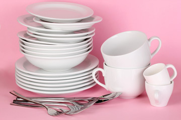 Clean white dishes on pink background