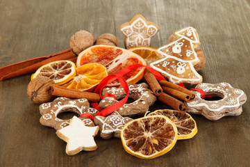 Dried citrus fruits, spices and cookies on wooden table