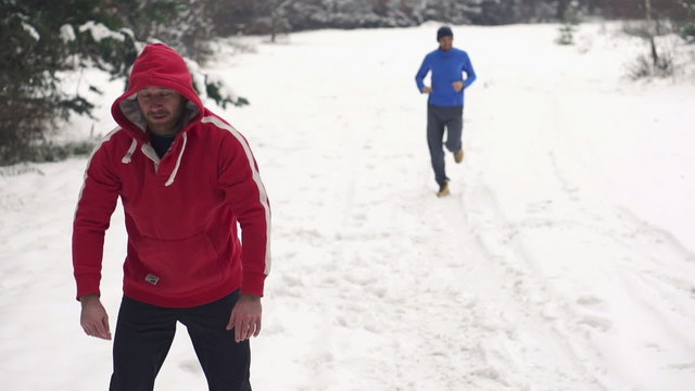 Man warming up, man jogging in winter, slow motion