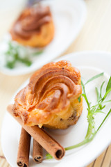 brown cupcake on a white plate, two