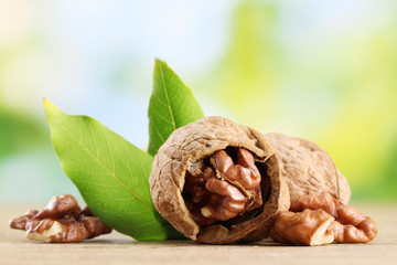 walnuts with green leaves, on green background