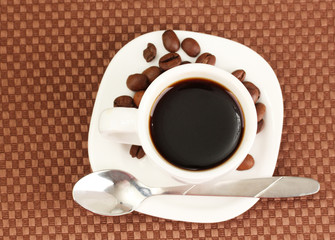 Cup of coffee on brown background