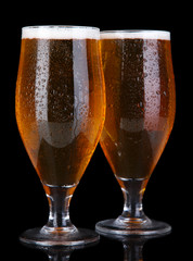 Glasses of beer isolated on black