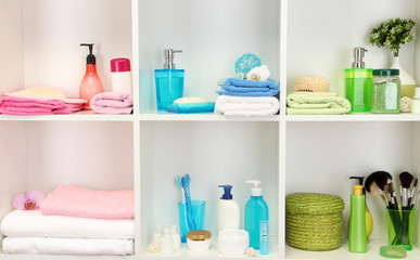Bath accessories on shelfs in bathroom