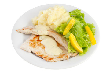 fried turkey with sauce, potato and fresh salad on the plate