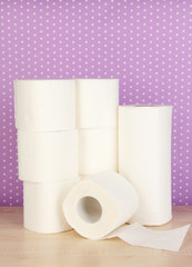 Rolls of toilet paper on purple with dots background