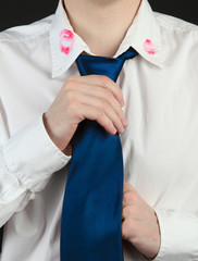 Lipstick kiss on shirt collar of man, isolated on black