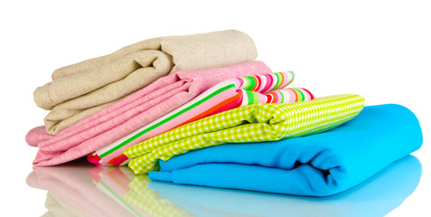 Pile of different fabrics isolated on white