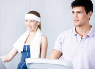 Fototapeta premium Young woman in sportswear training on gym