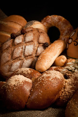 assortment of baked bread on sacking