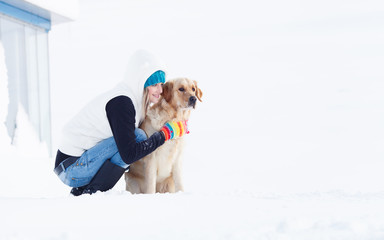 Girl in winter suit on a walk with her labrador. Girl in winter