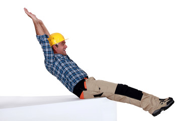 Tradesman stretching his body