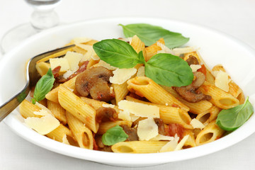 Penne pasta with mushroom sauce, parmesan and basil