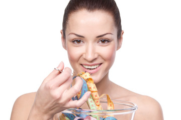 Humorous portrait of a young woman keeping a diet and eating mea