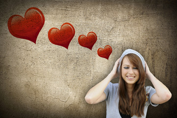 Happy girl over wall with hearts