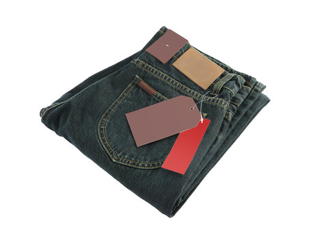 Dark blue folded jeans and blank label on white background.