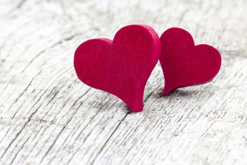two red hearts on wooden background