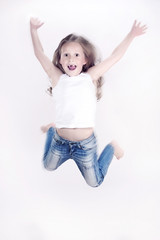 Little girl jumping over the white background