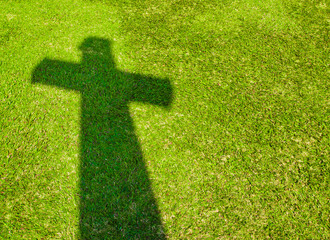 Shadow of Cross on  green grass