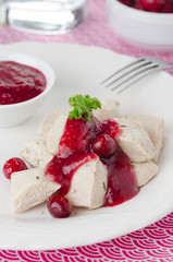 boiled chicken breast with cranberry sauce closeup