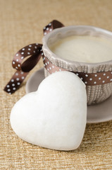cookie with icing in the form of heart and a cup of coffee