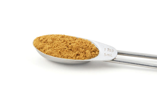 Ground cumin measured in a metal teaspoon