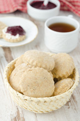 Scone of whole wheat in a wicker basket vertical