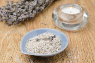 Fototapeta na wymiar sea ​​salt with lavender and candle on wooden table