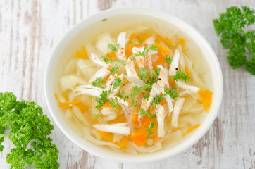 vegetable soup with chicken and parsley top view