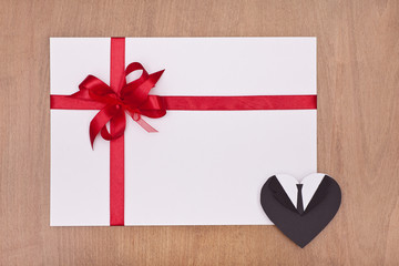 blank card with red ribbon and male heart