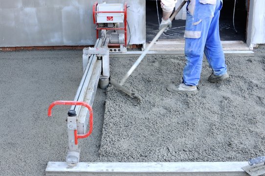 Construction site - machine running screed flooring