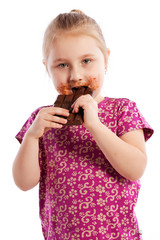 Young girl eating a chocolate bar.