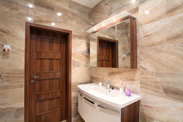 bathroom in luxury home with bath and furniture