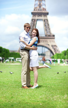 Closeup of happy positive couple hugging near the Eiffel tower
