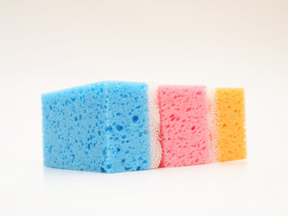 Pink, blue and orange sponge, isolated towards white background