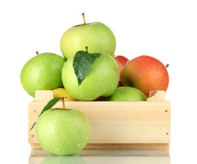 sweet apples in wooden crate, isolated on white