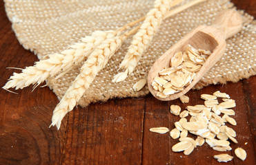 Oat flakes in wooden bowl on the table