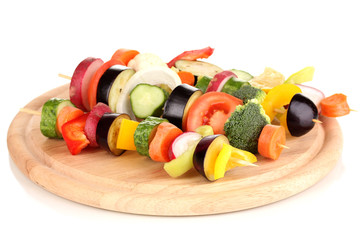 Sliced vegetables on wooden picks isolated on white