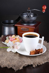 White cup of Turkish coffee with rahat delight, coffee pot and