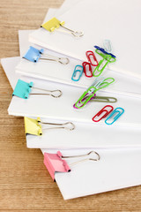 Documents with binder clips on wooden table