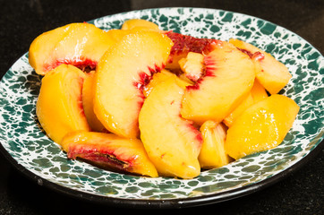 Fresh peaches sliced into a bowl