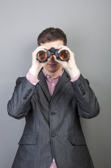 Businessmen looking through binocular