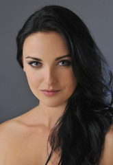 Fototapeta premium Attractive young brunette woman with blue eyes