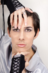 Fashionable and seductive guy portrait with mitens
