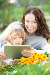 Family using tablet PC outdoors
