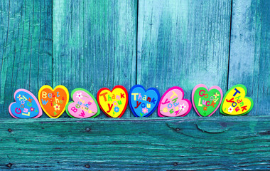 Decorative hearts on wooden background