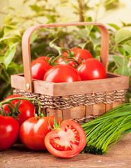 Tomatoes and green onions in a wattled basket