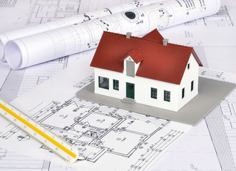 House model on a plan of a house construction