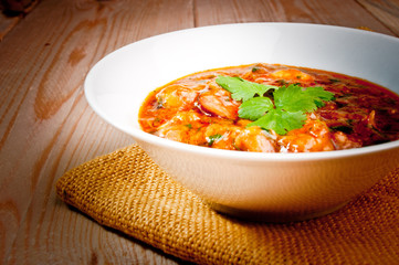 shrimp in a sauce on a wooden table
