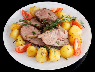 Rack of lamb with fried potatoes isolated on black